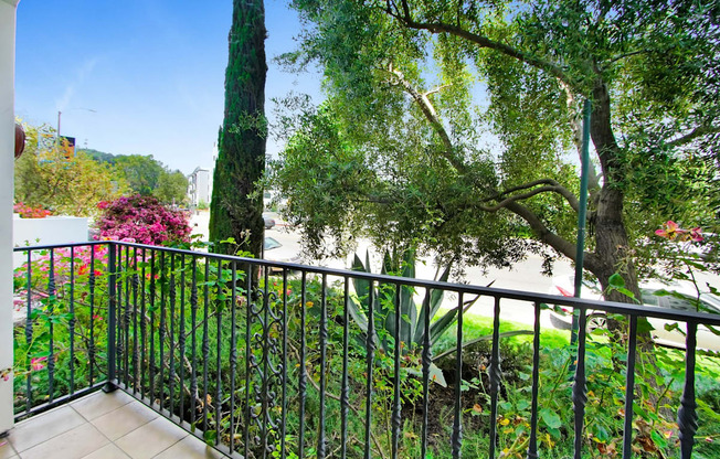 a balcony or terrace with a view of a garden