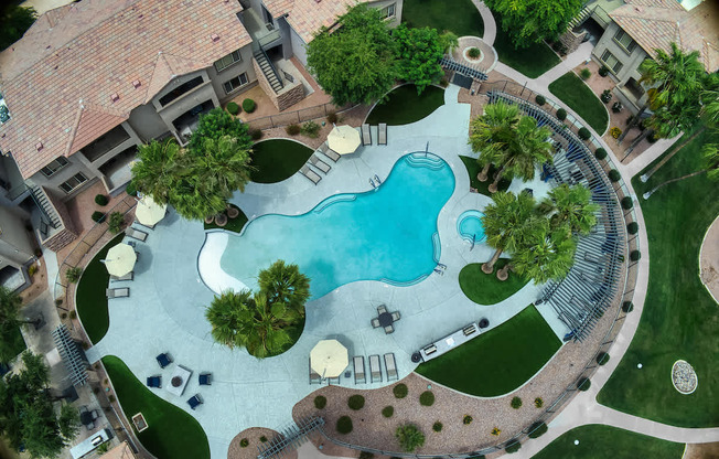 A large backyard with a pool and a patio area.