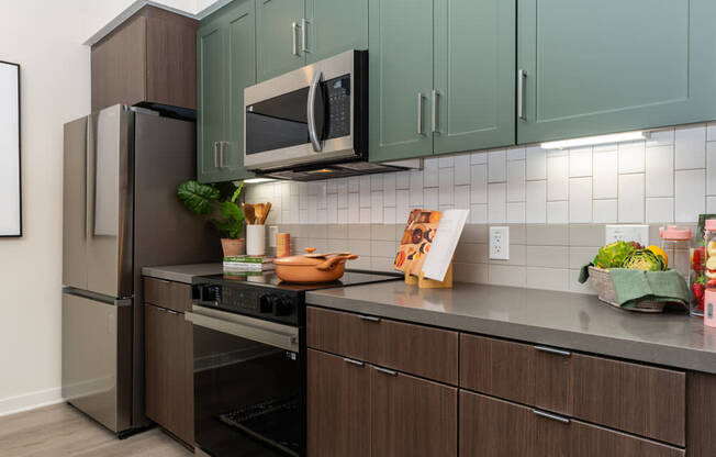 A kitchen with brown cabinets and a black oven.