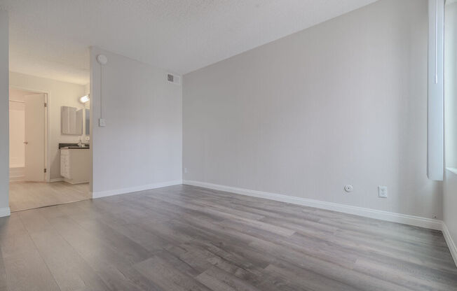 an empty living room with wood flooring and white walls at City View Apartments at Warner Center, Woodland Hills, CA 91367