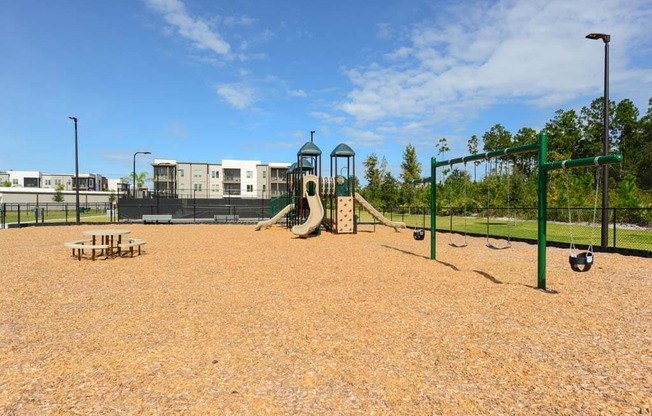 a playground with a slide and monkey bars in front of a building at Luxor Club, Jacksonville, FL