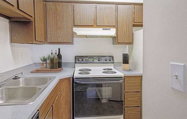 A modern kitchen with wooden cabinets and stainless steel appliances.