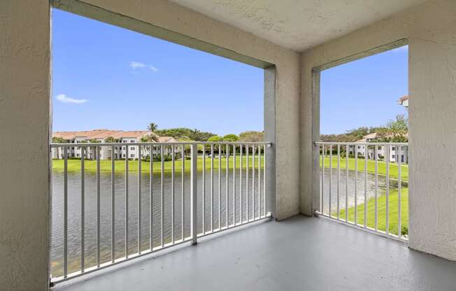 a balcony with a view of a body of water and a fence