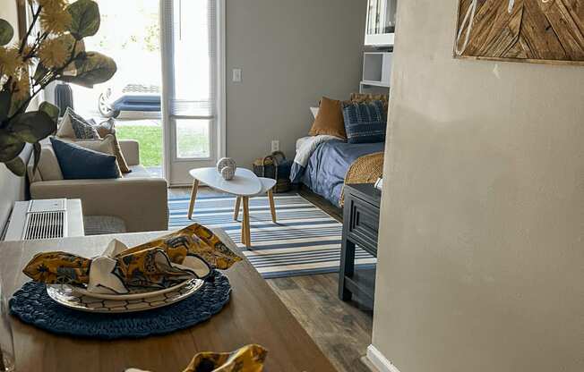 a living room and dining room with a table with plates on it