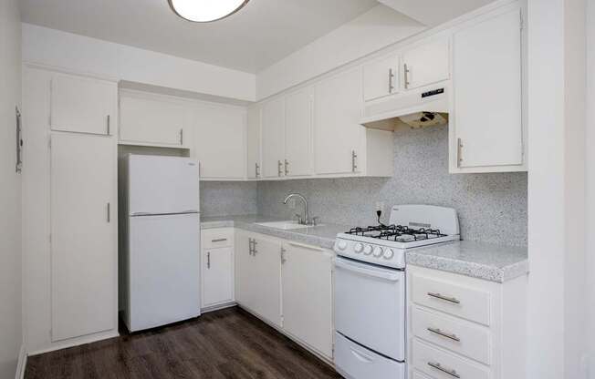 a kitchen with white appliances and white cabinets