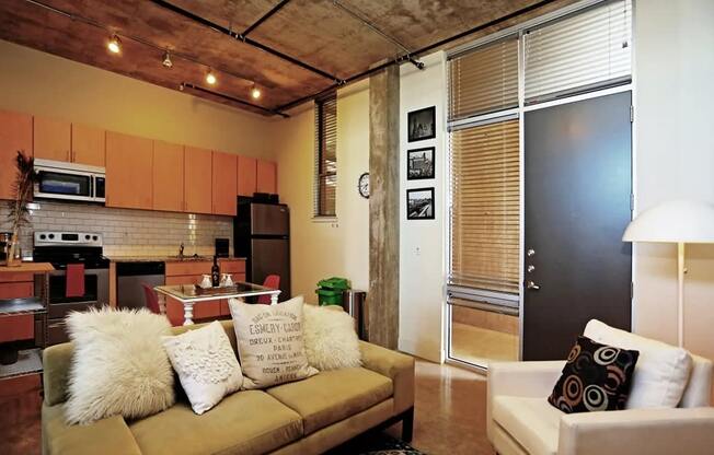 a living room with a couch and a kitchen