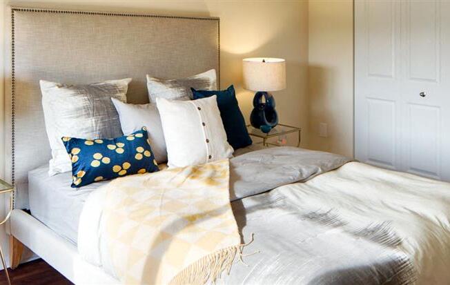 Bedroom with cozy bedat Riverside Apartments, Virginia