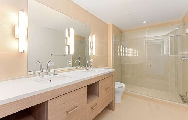 a bathroom with two sinks and a toilet