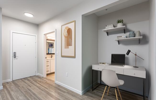 a home office with a white desk and a white chair