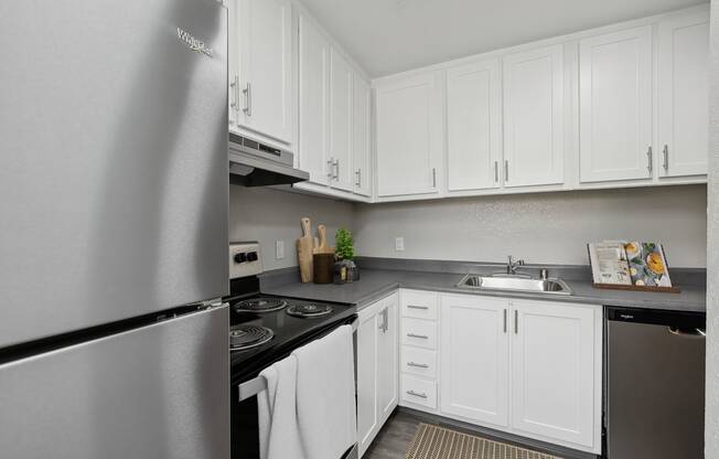 a kitchen with stainless steel appliances and white cabinets