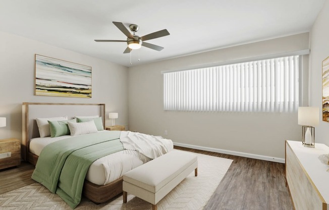 a bedroom with a bed and a ceiling fan