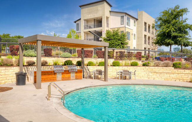 a swimming pool with a building in the background