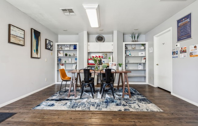 a dining room with a wooden table and chairs and a book shelf