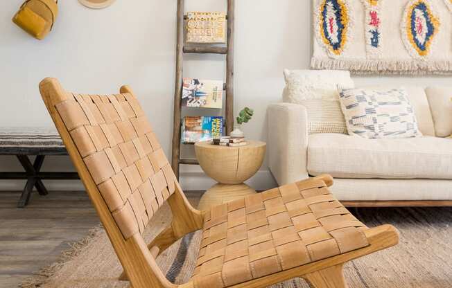 a living room with a wooden chair and a white couch