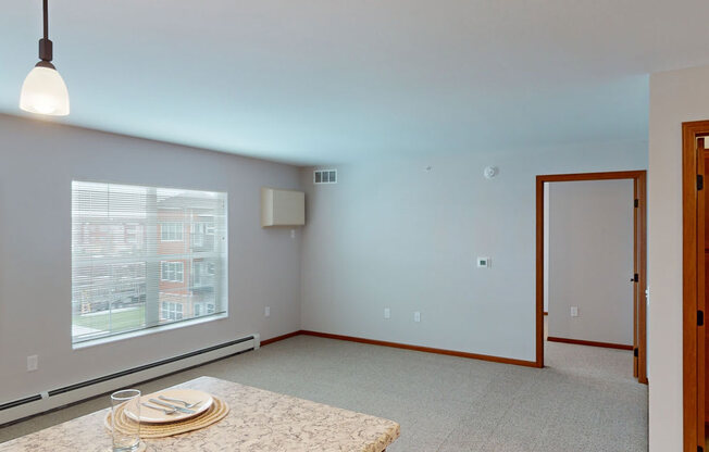 a living room with a large window and a table