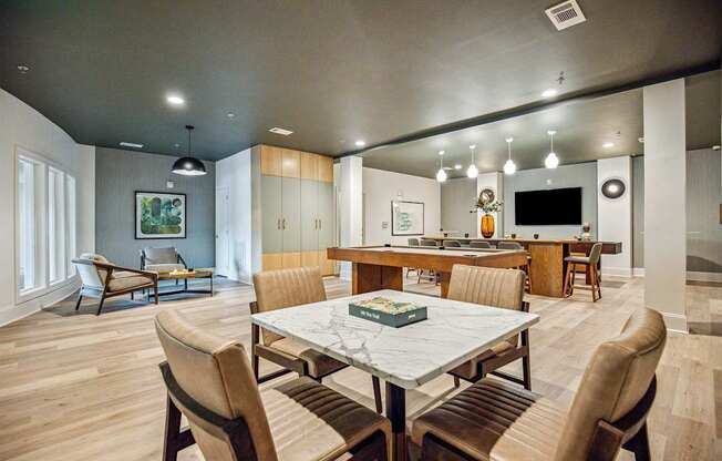 A modern dining room with a large table and chairs.