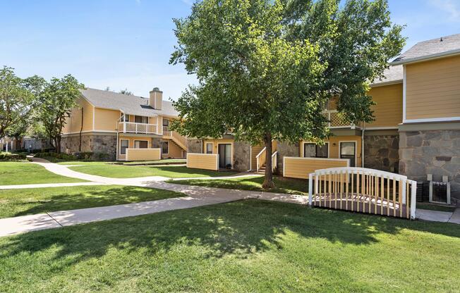 Walking paths surrounded by grass and shade trees throughout Edmond, OK apartment community