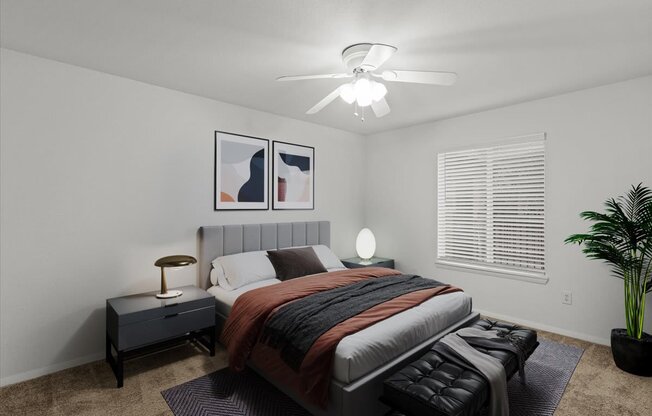 a bedroom with a bed and a ceiling fanat Millcreek Woods Apartments, Olathe, KS