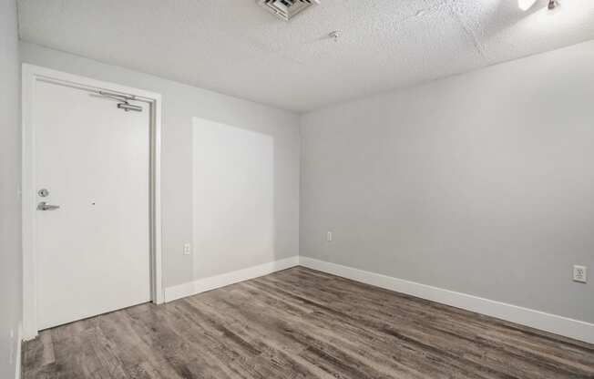 a bedroom with gray walls and a white door