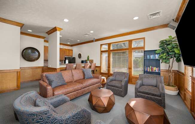 A living room with a brown couch and a blue chair.