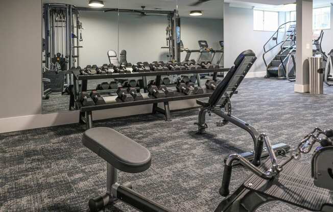 a room filled with cardio equipment and weights