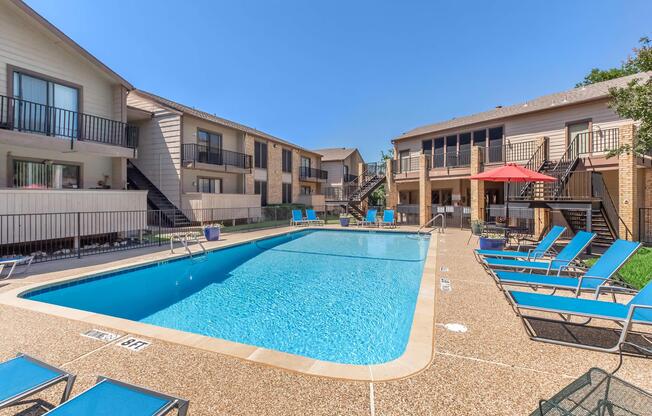 a house with a pool in front of a building