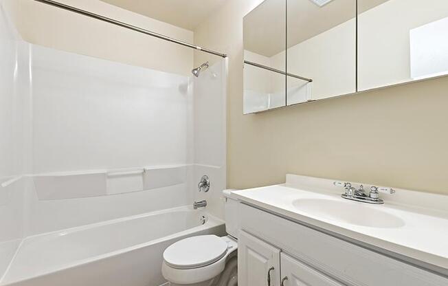 Bathroom with white cabinets and tub at Barracks West in Charlottesville, VA