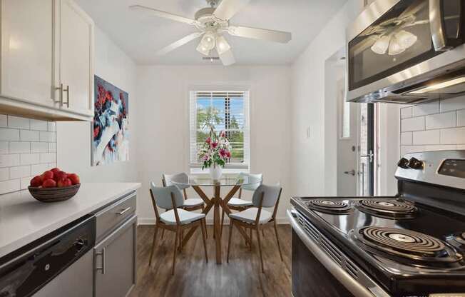 A modern kitchen with a dining table set for four.