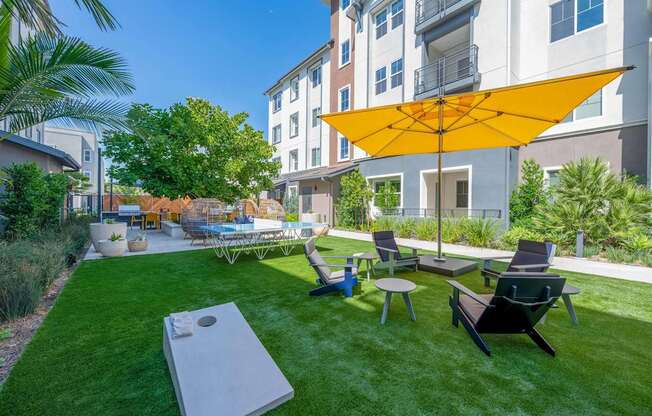 outdoor lounge area with cornhole