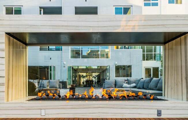 A modern house with a fire pit in the front yard.