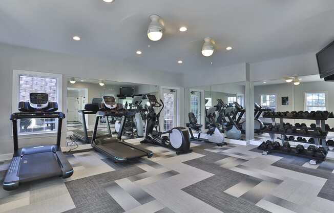 a gym with treadmills and other exercise equipment