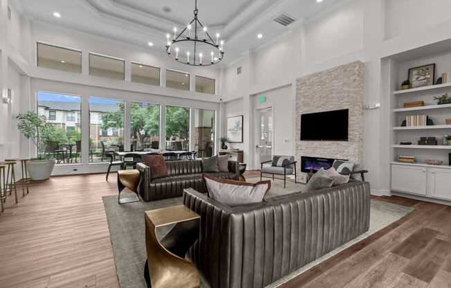 A modern living room with a brown leather couch and a fireplace.