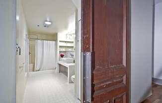 a bathroom with a shower and a wooden door