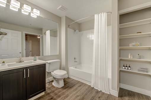 A white bathroom with a toilet, sink, and bathtub.