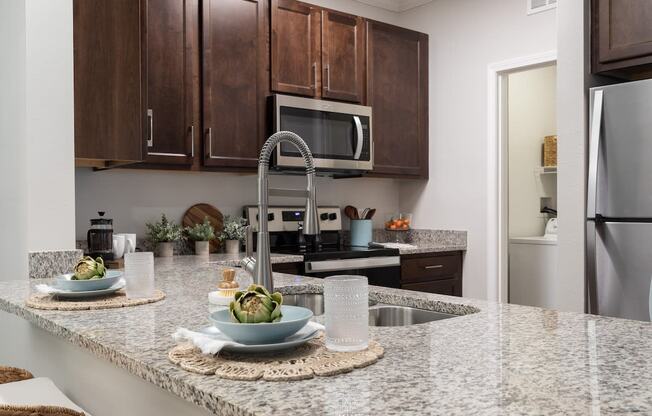 a kitchen with granite counter tops and stainless steel appliances