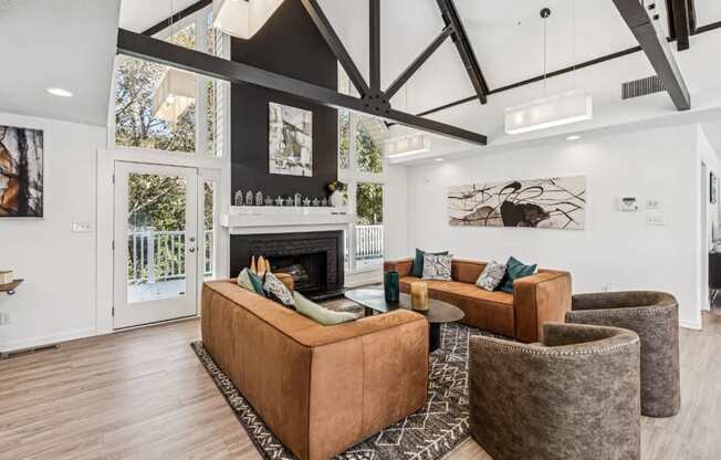 A living room with a fireplace and a brown couch.