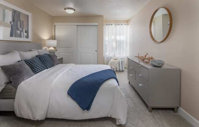 a bedroom with a large bed and a dresser