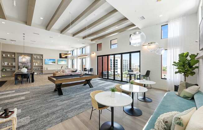 a living room with a pool table and couches