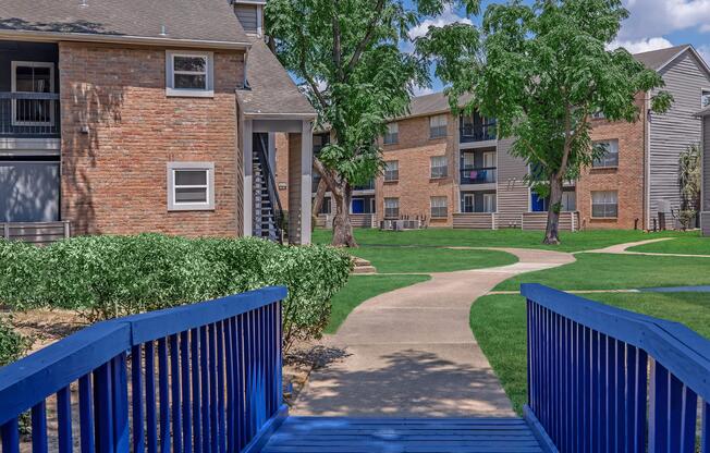 a wooden bench sitting in front of a brick building