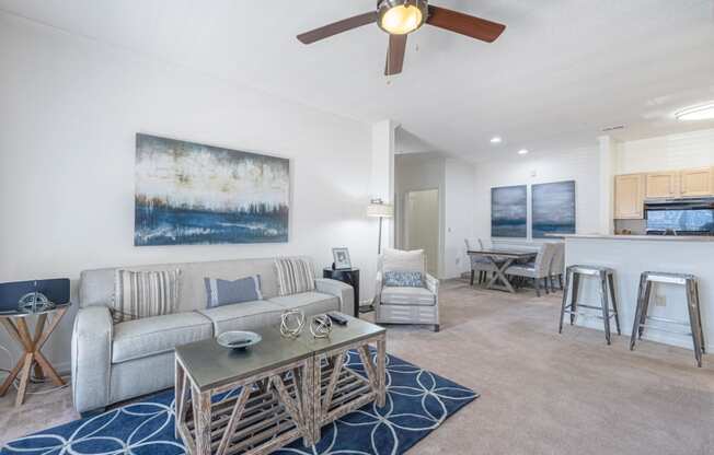 a living room with a couch and a ceiling fan