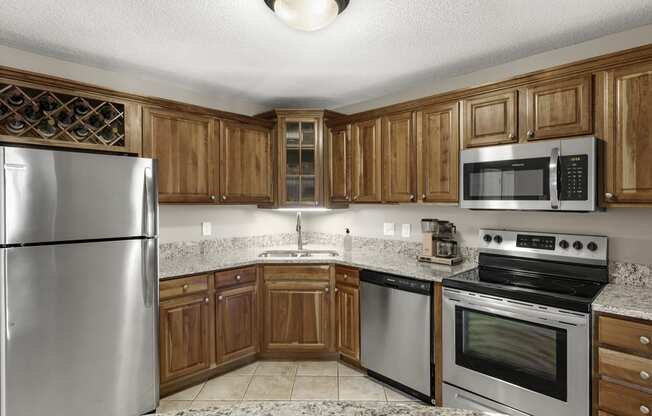 Kitchen with appliances and cabinets at The Riverwood, Lilydale, 55118