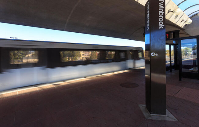 Twin book metro sign with metro rail train in background