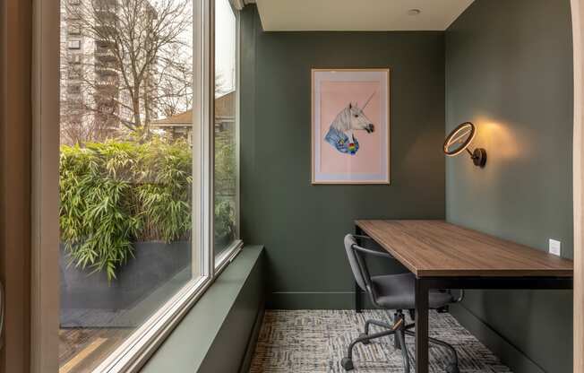 a room with a table and a window and a painting of a horse