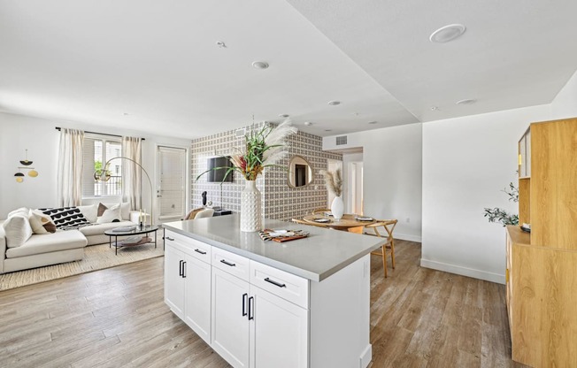 a kitchen with a large island and a living room