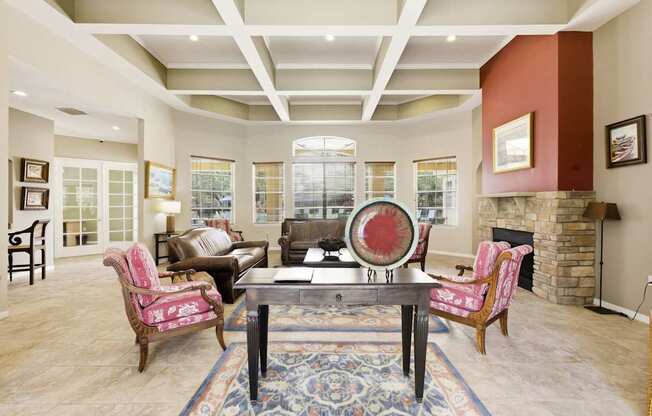 A living room with a fireplace and a large rug.