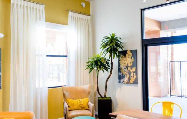 a living room with yellow walls and orange and blue furniture