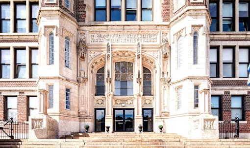 the facade of a building with stairs and an entrance