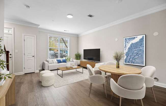 A living room with a white couch, a wooden coffee table, and a large painting on the wall.