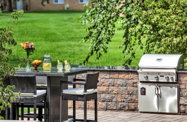 Outdoor dining area near BBQ grills at Franklin Commons apartments for rent in Bensalem, PA