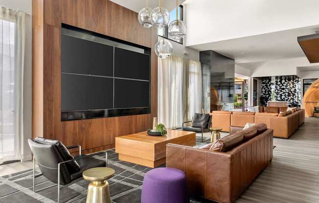 A modern living room with a large flat screen TV mounted on the wall.
